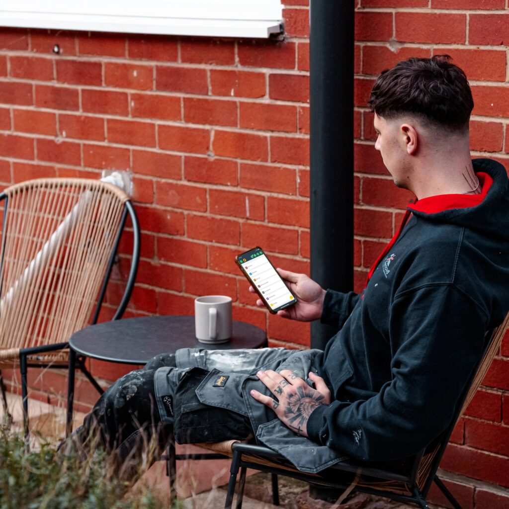 tradesperson tracking expenses with Powered Now