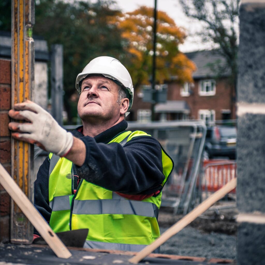 Builder using construction management software on site