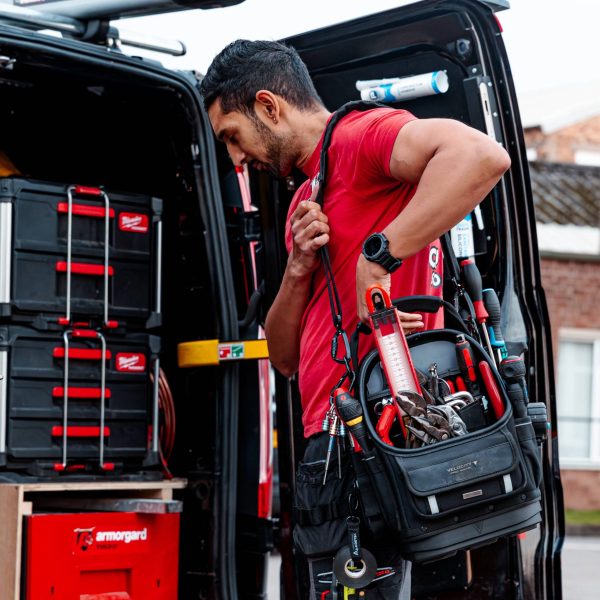 tradesperson putting tools in van